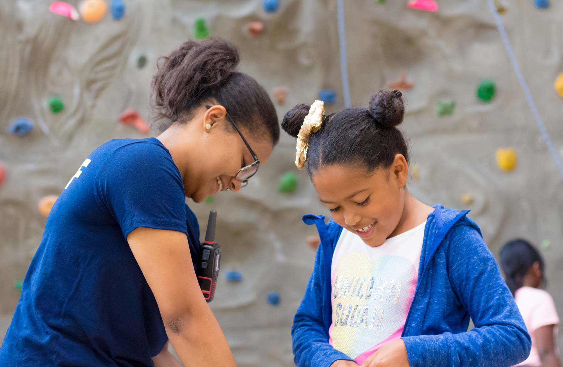 two African American girls at the rock climbing wall
