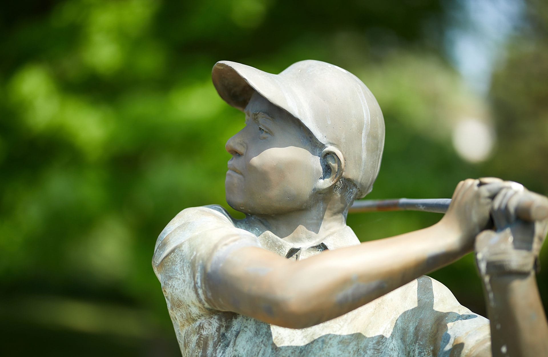 statue of boy holding baseball bat ready to swing