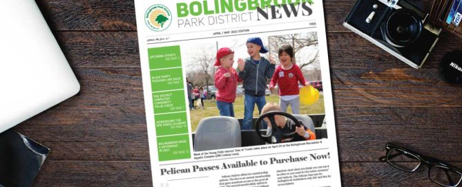 Bolingbrook Park District Newsletter laying on top of desk with photo of three young children on the cover.