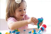 Young girl playing with playdough