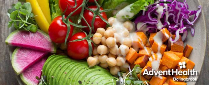 Plate full of tomatoes, chickpeas, sweet potato, coleslaw and avocado