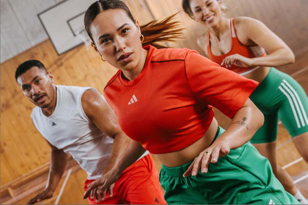3 people in workout clothes exercising