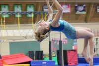 Young Caucasian girl doing a gymnastics flip