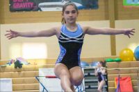 Young Caucasian girl on balance beam