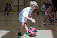 Young Caucasian boy bouncing a basketball