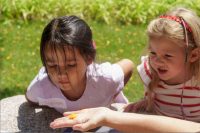 two young girls learning about nature