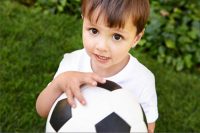 Young Caucasian boy holding a soccer ball