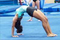 Young Hispanic girl doing gymnastics