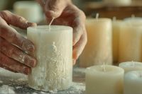 hands of a man making a candle