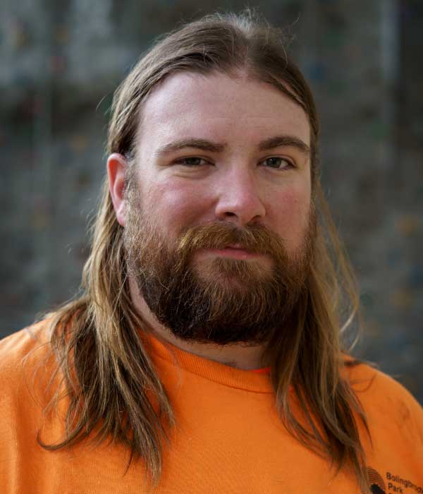Middle-aged caucasian mail with long hair and beard smiling
