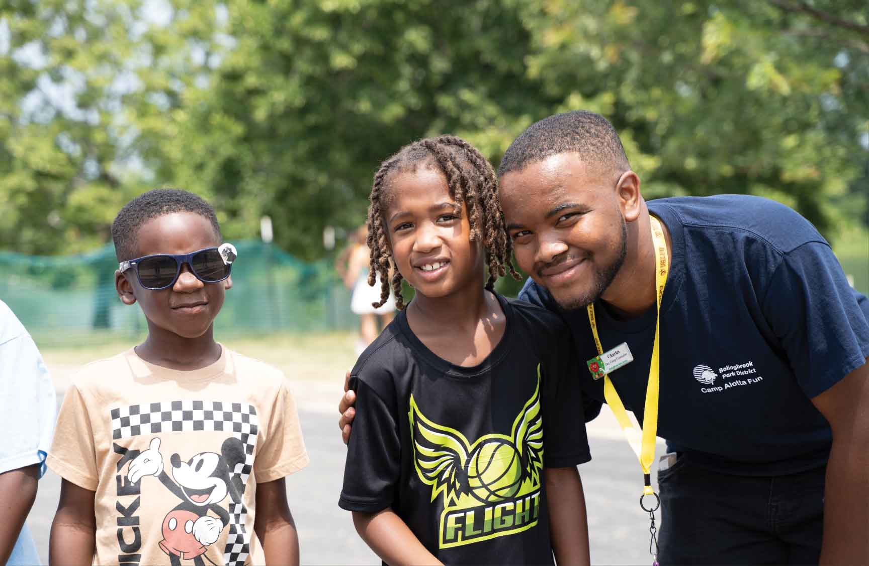 Three African-American kids smiling and enjoying summer camp