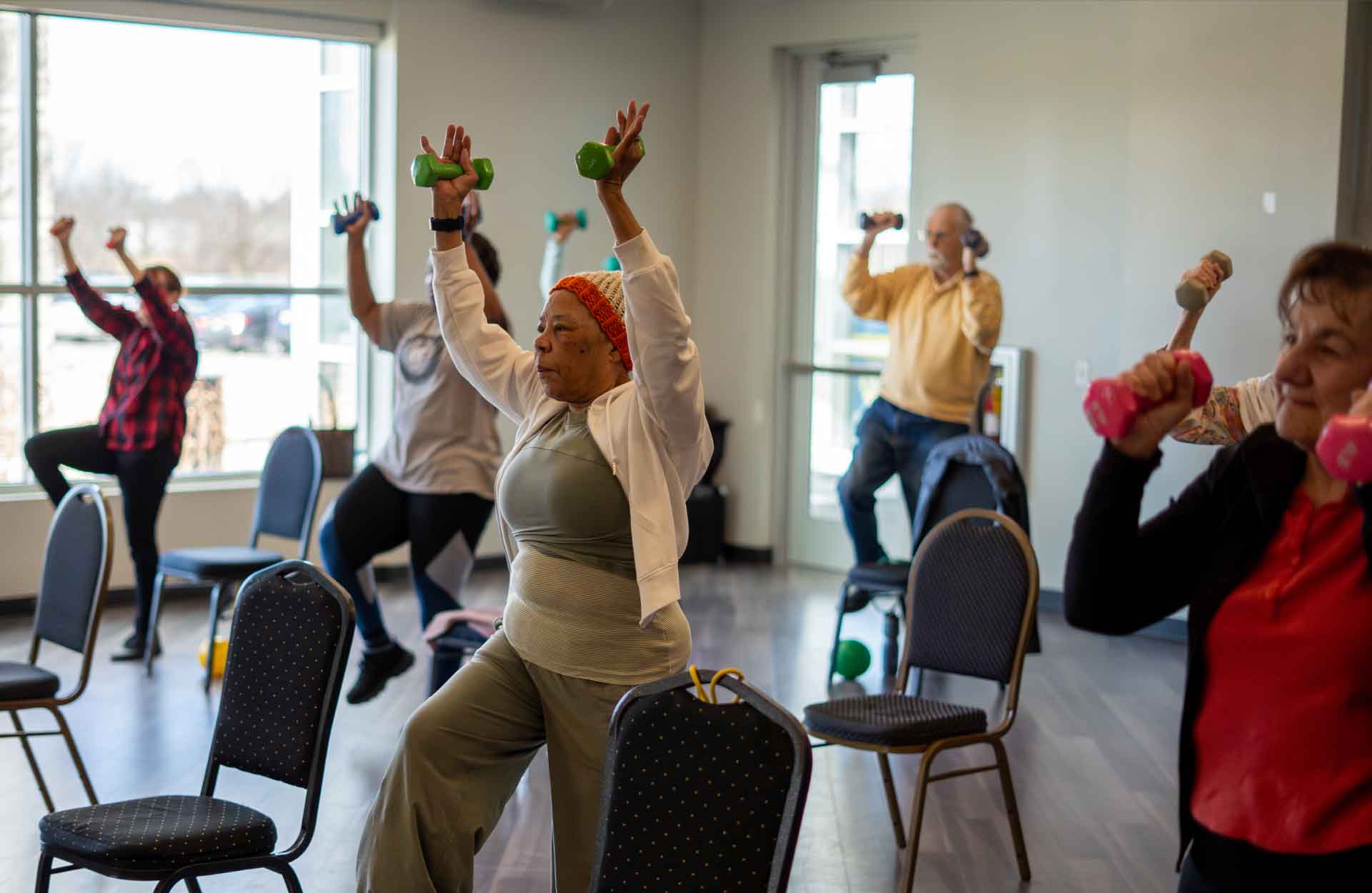 Group of seniors of different nationalities participating in a group fitness class